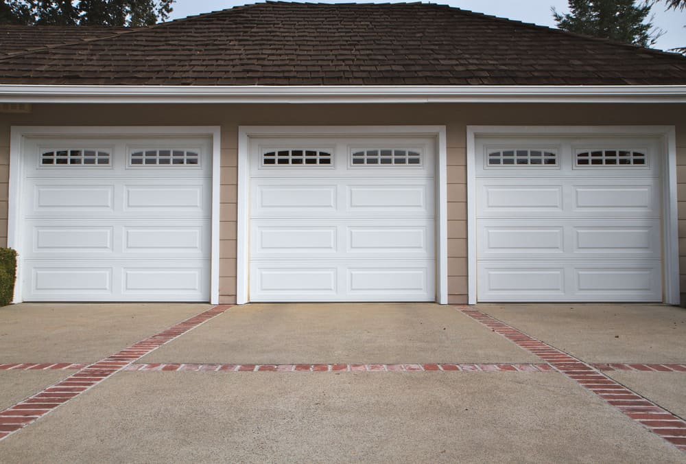 Three white garage doors