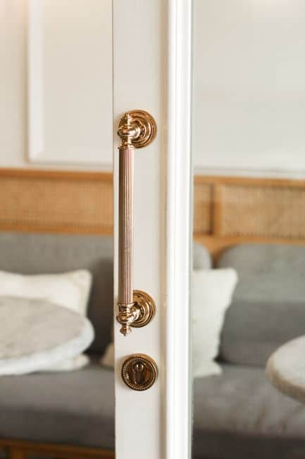 A brass doorknob on a white wooden door