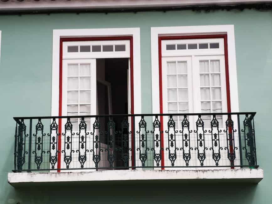 White French doors opening onto a balcony with an iron railing