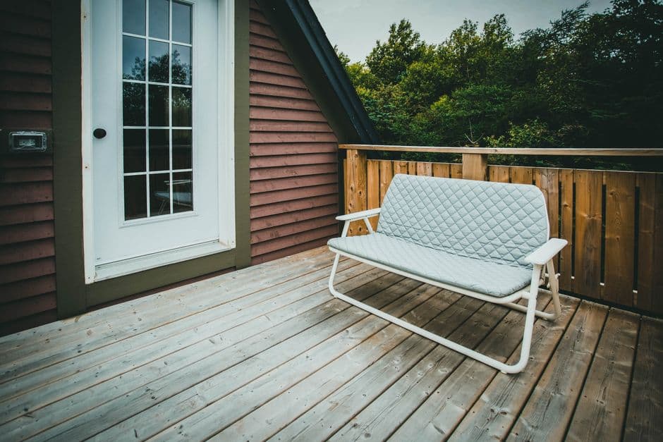 White glazed door opening onto a wooden deck