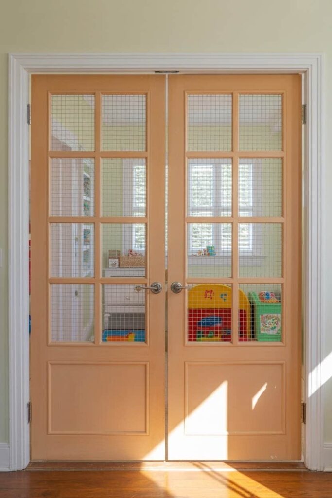 French doors separating a playroom from a main living area
