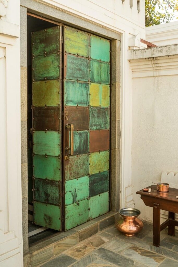 mandir door clad in oxidized copper