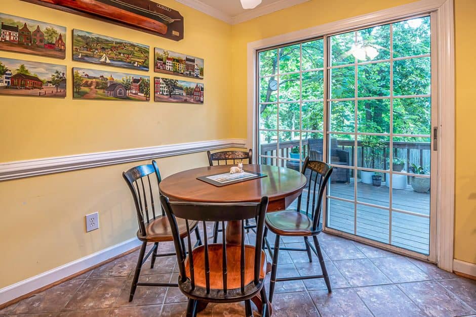 Sliding glass patio door in a dining room looking out to a wooden deck